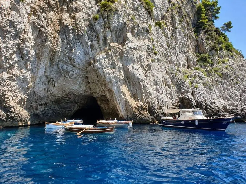 Rowing boats waiting at the mouth of the Blue Grotto on Capri