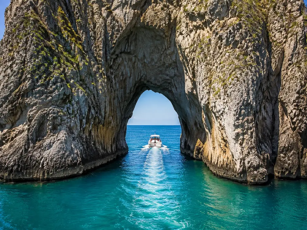 The Faraglioni sea stacks off Capri, with the arch through the middle stack