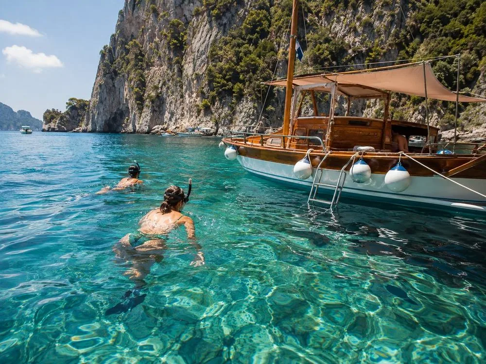 A swim stop in clear water on a Capri boat tour from Sorrento